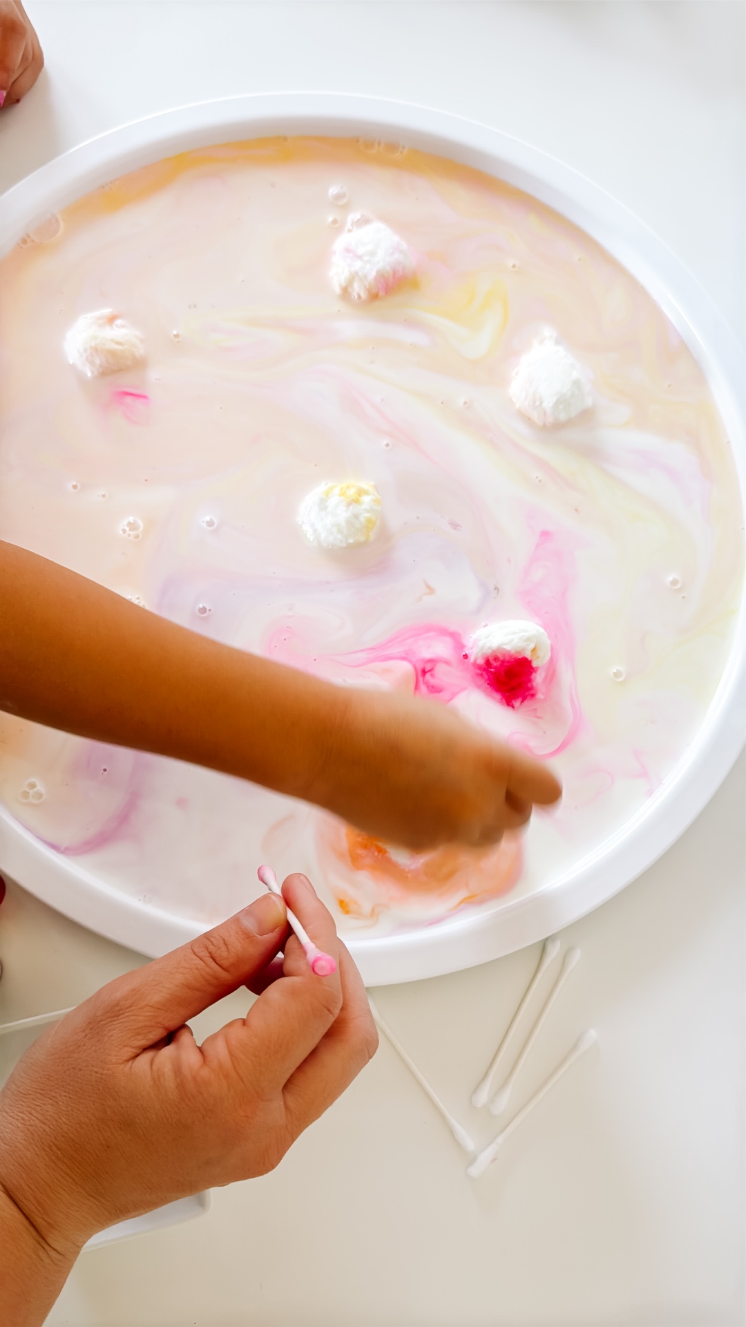 Warm pastel colors blending across milk as a child experiments