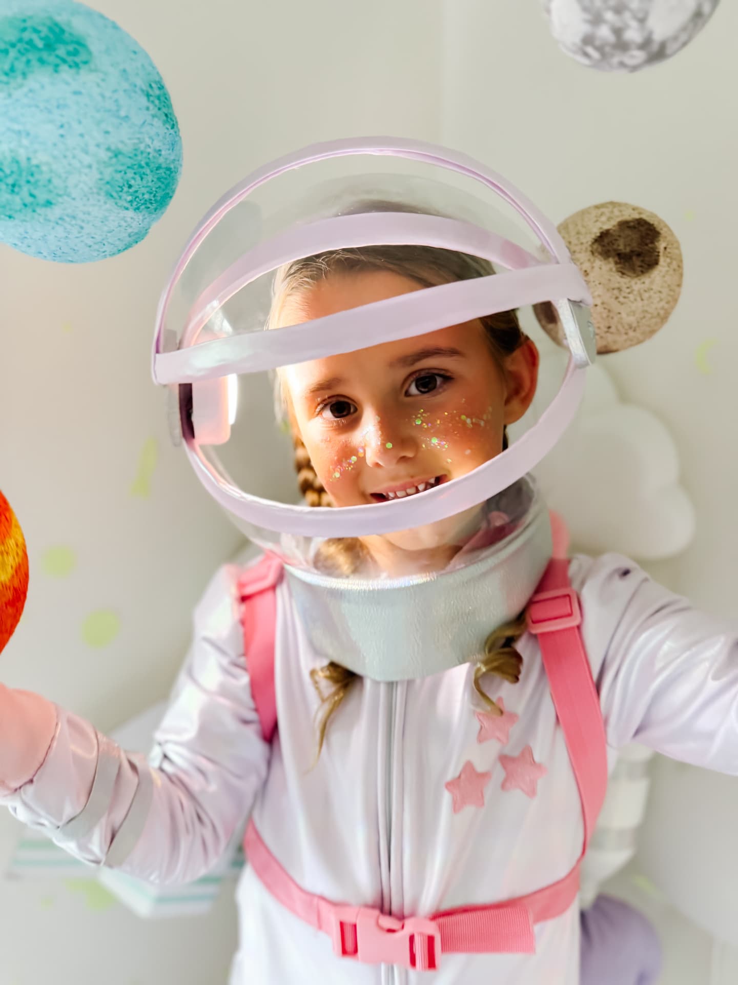 Close-up of the DIY astronaut helmet decorated with pastel planets
